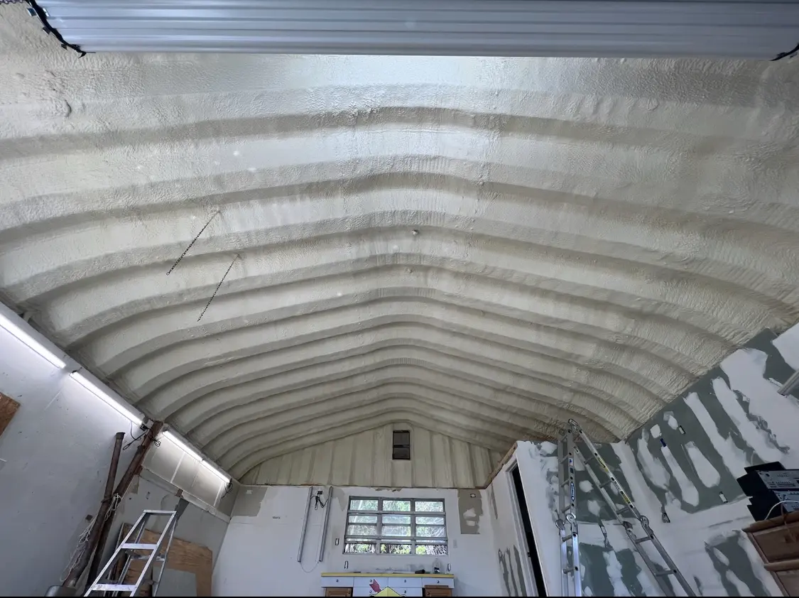 Spray polyurethane foam applied to the underside of a metal roof deck in Grafton